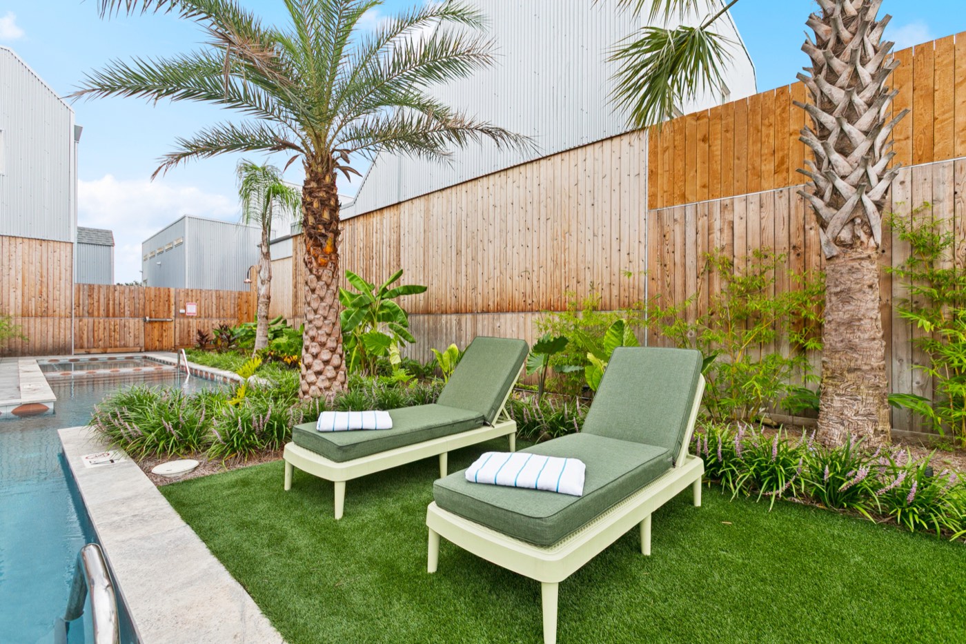 Pool loungers and palm trees at a private New Orleans villa