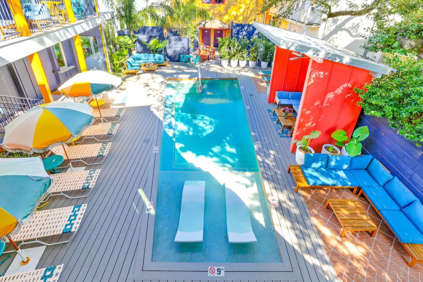 Colorful courtyard pool with umbrellas at The Syd, seen from above